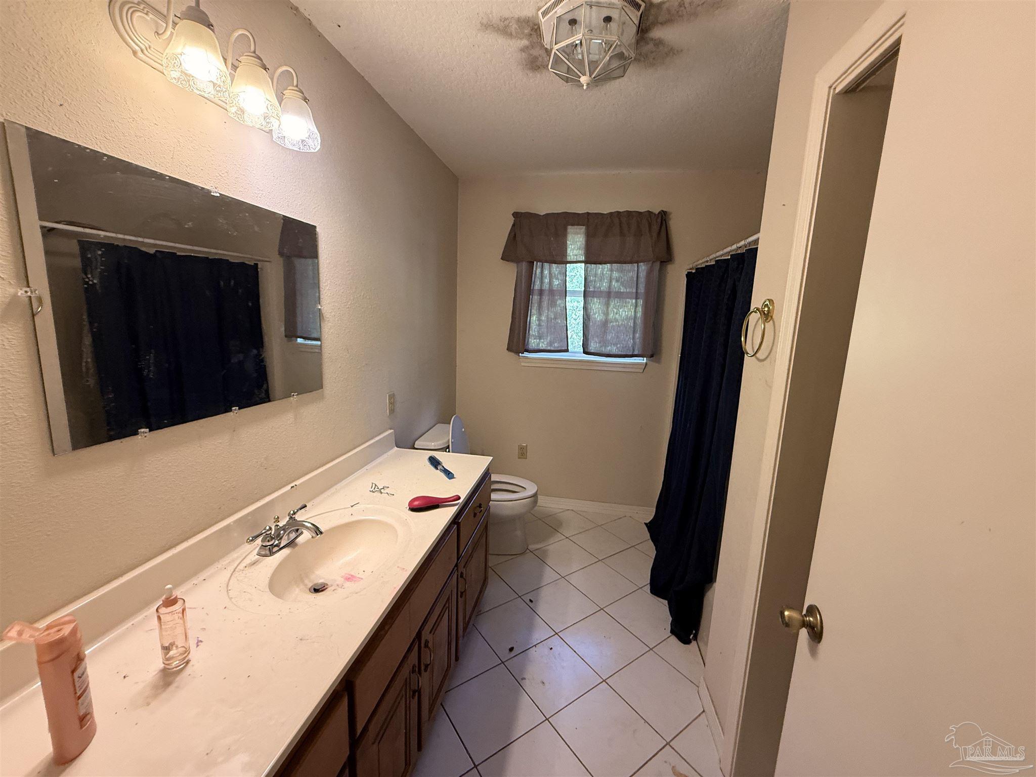 9543 Quiet Creek Road Milton, FL 32570 - Photo 32 of 45 a bathroom with a sink and a mirror