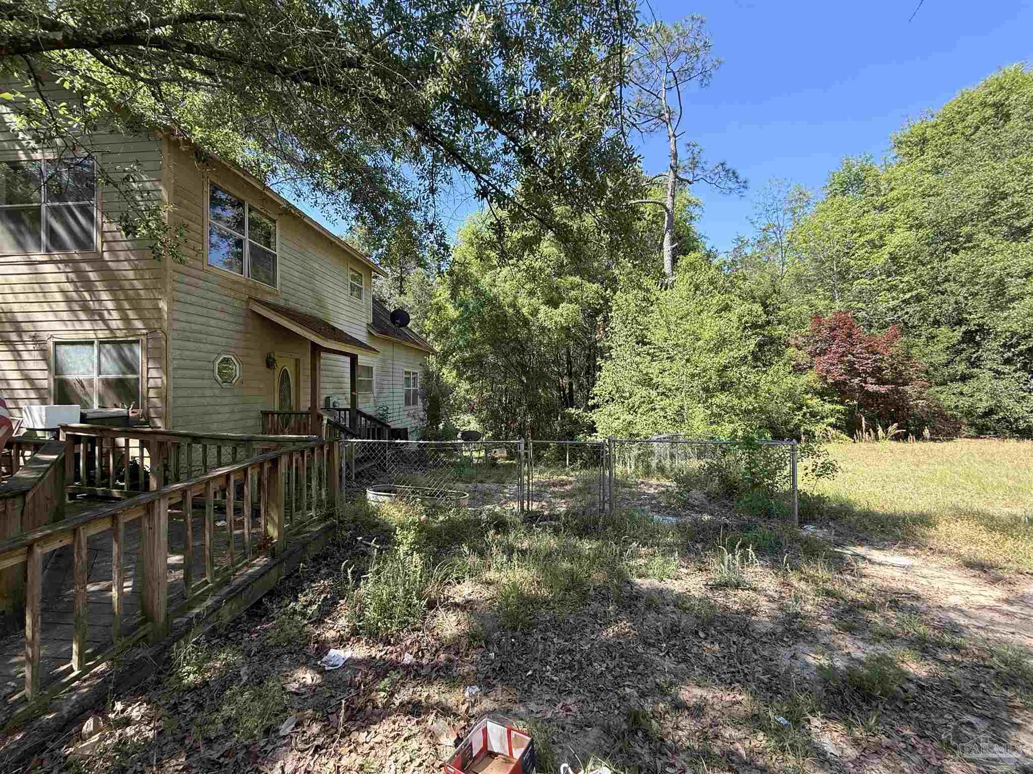 9543 Quiet Creek Road Milton, FL 32570 - Photo 5 of 45 a view of a house with a yard