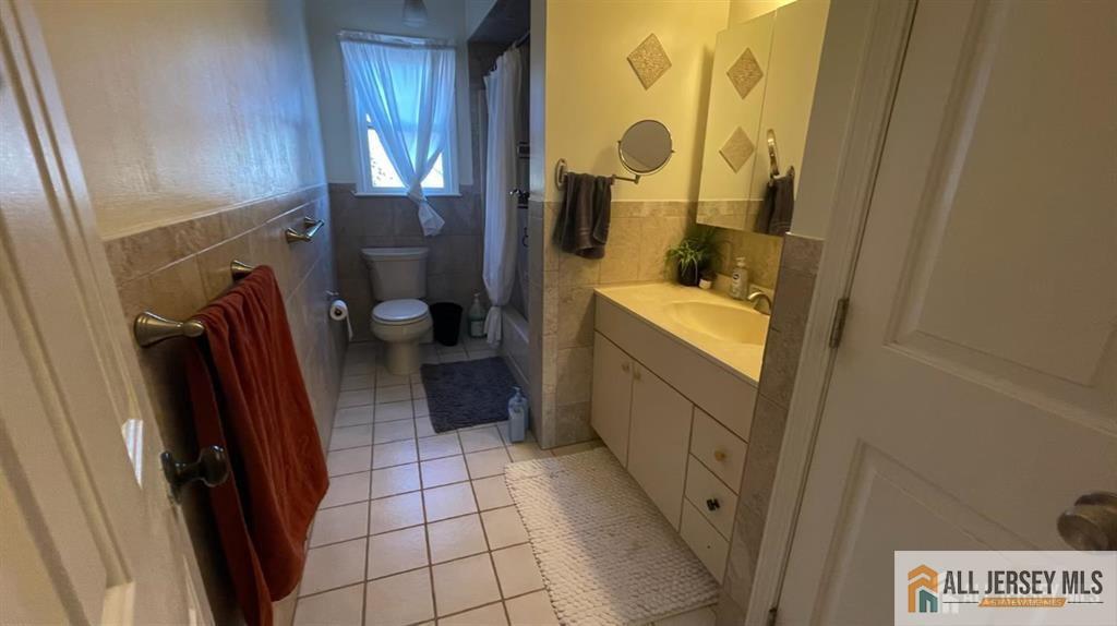 102 Gracey Street Edison, NJ 08817 - Photo 13 of 16 a bathroom with a sink a toilet and a shower