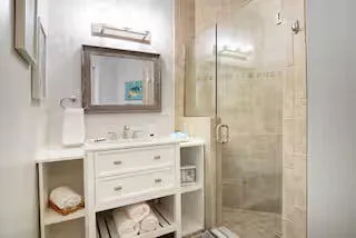 a view of a room with wooden floor and white walls