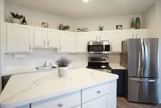 a kitchen with a sink a microwave and refrigerator