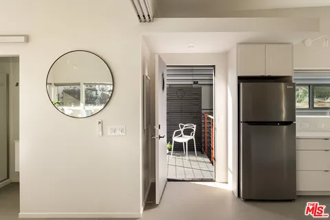 a kitchen with stainless steel appliances a refrigerator and a stove top oven
