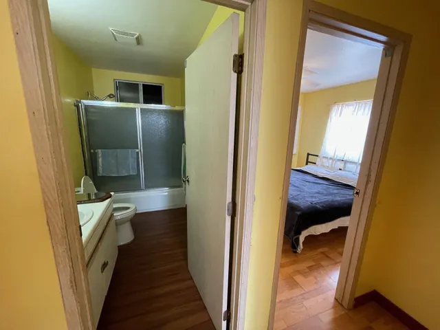 a view of hallway with wooden floor
