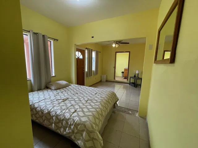 a bedroom with a bed mirror and a dresser