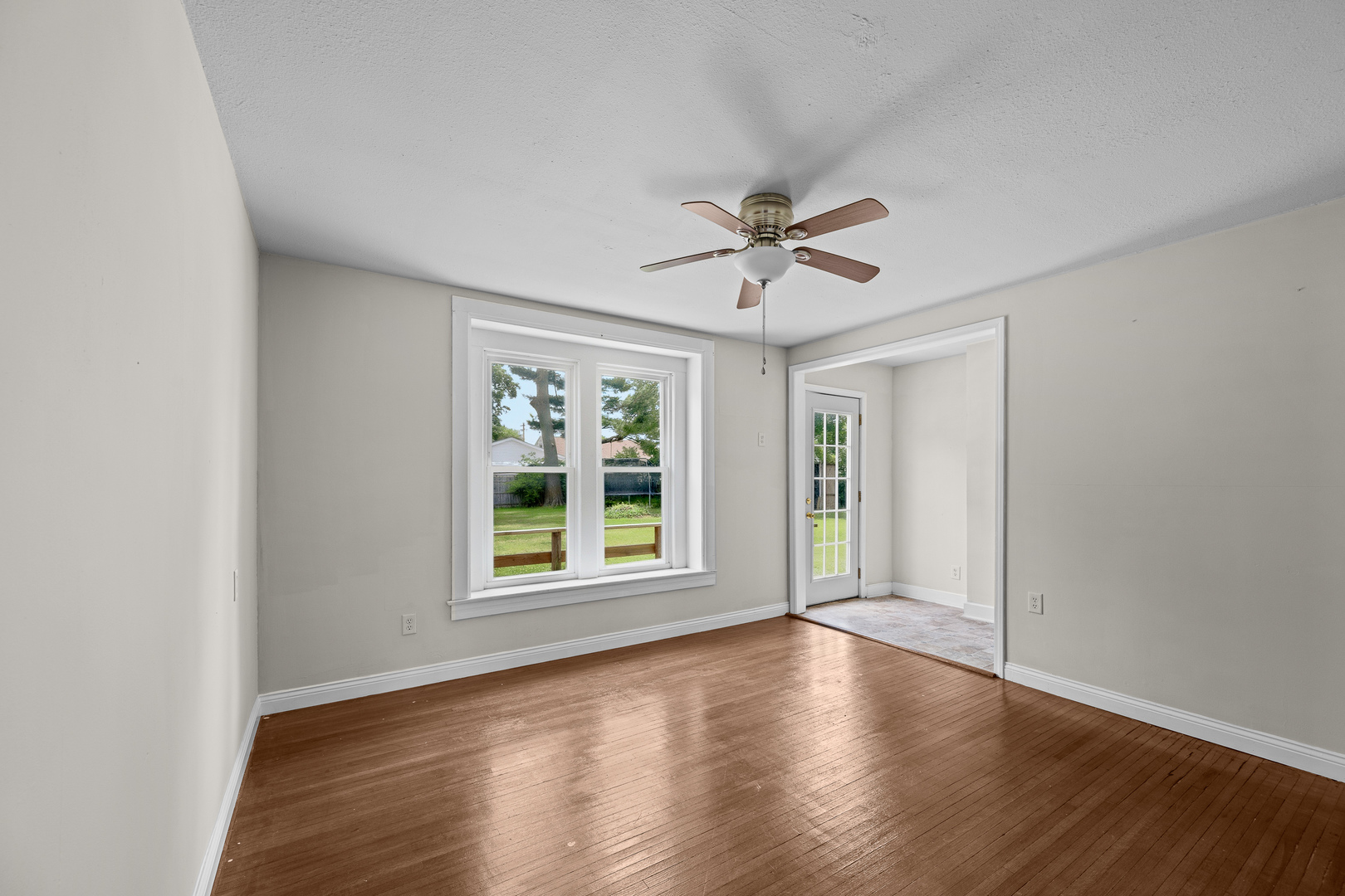 1202 20th Avenue Viola, IL 61486 - Photo 27 of 50 an empty room with wooden floor and windows
