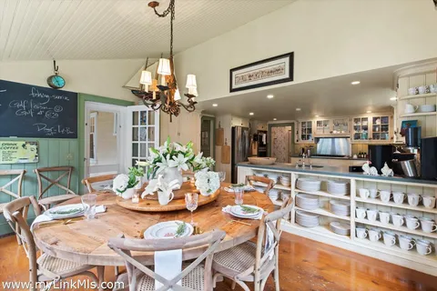 a view of a dining room with furniture and a chandelier