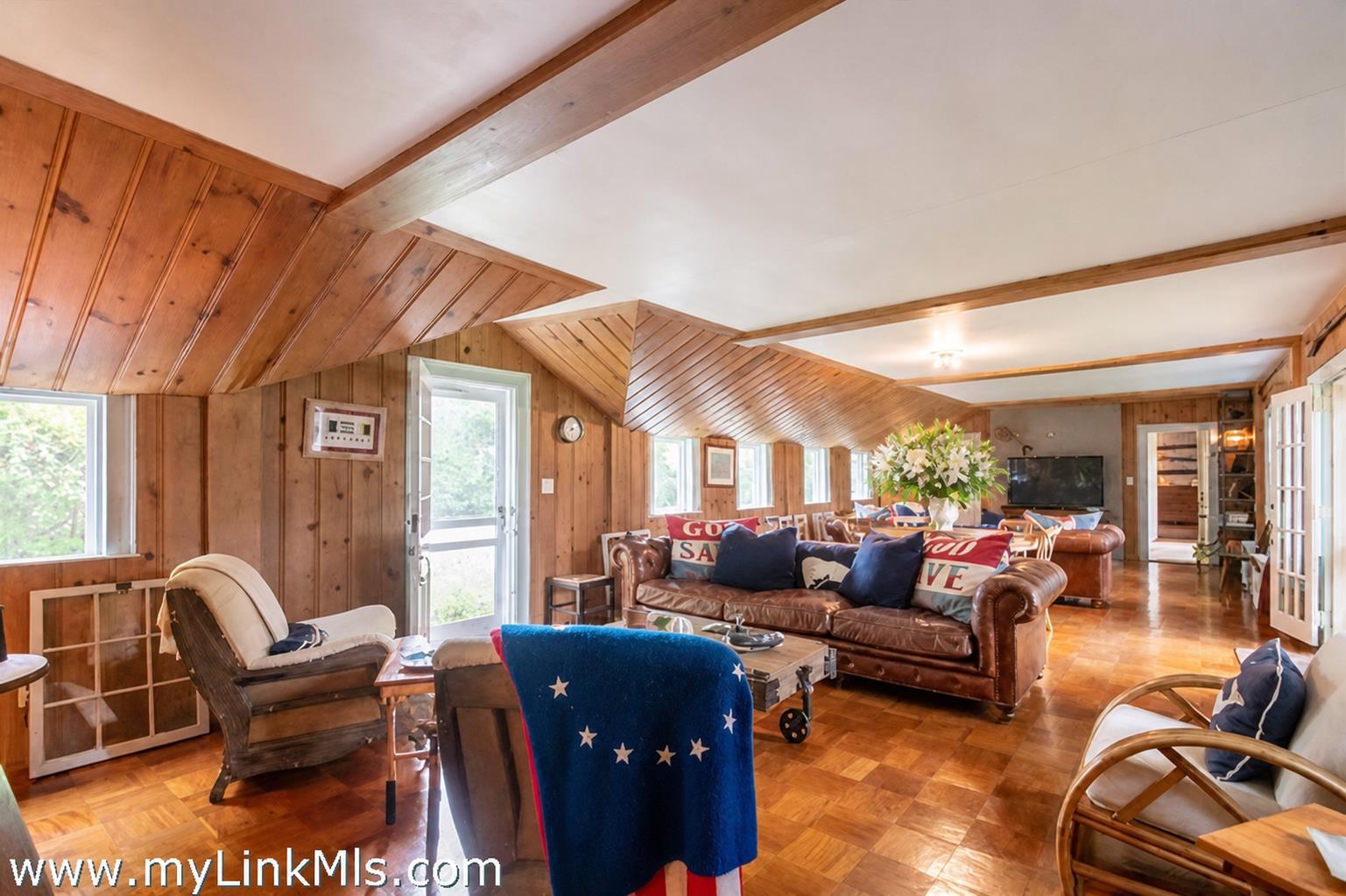 20 Main Street Nantucket, MA 02554 - Photo 21 of 33 a living room with furniture a fireplace and large windows