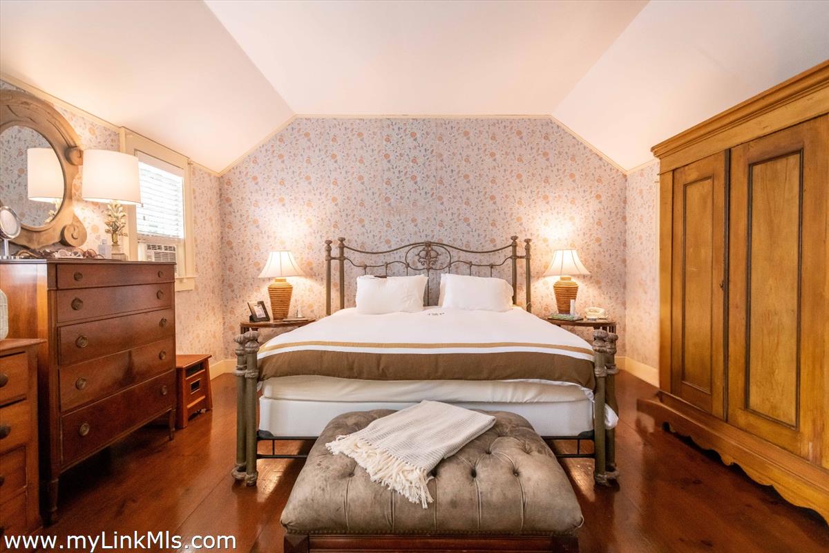 20 Main Street Nantucket, MA 02554 - Photo 24 of 33 a bedroom with a bed and wooden floor