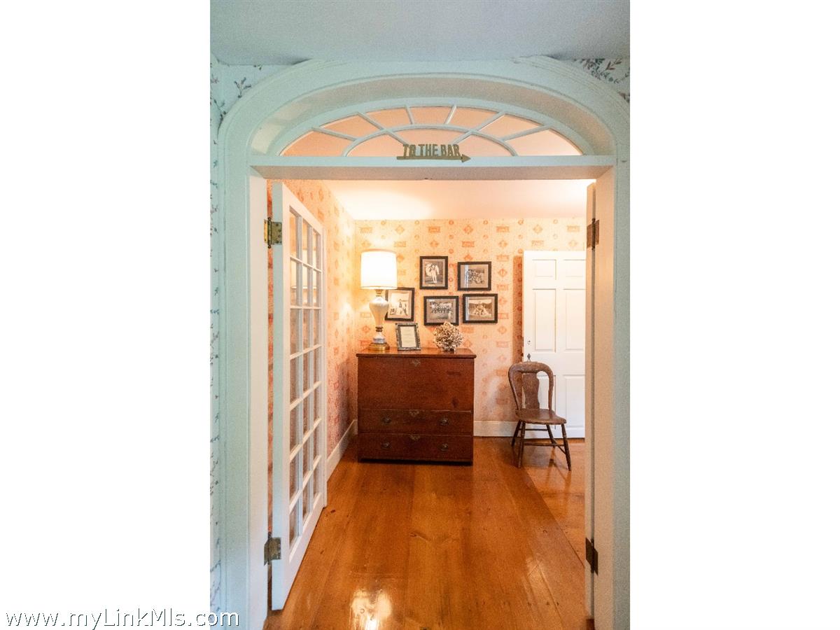 20 Main Street Nantucket, MA 02554 - Photo 4 of 33 a view of a living room with a fireplace and a floor to ceiling window