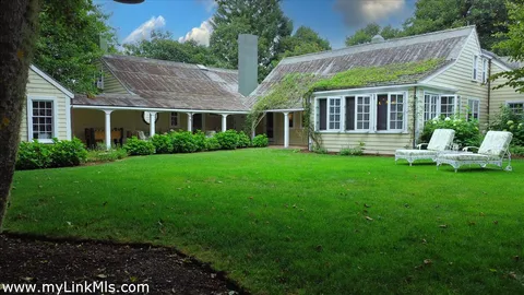 a front view of house with a garden