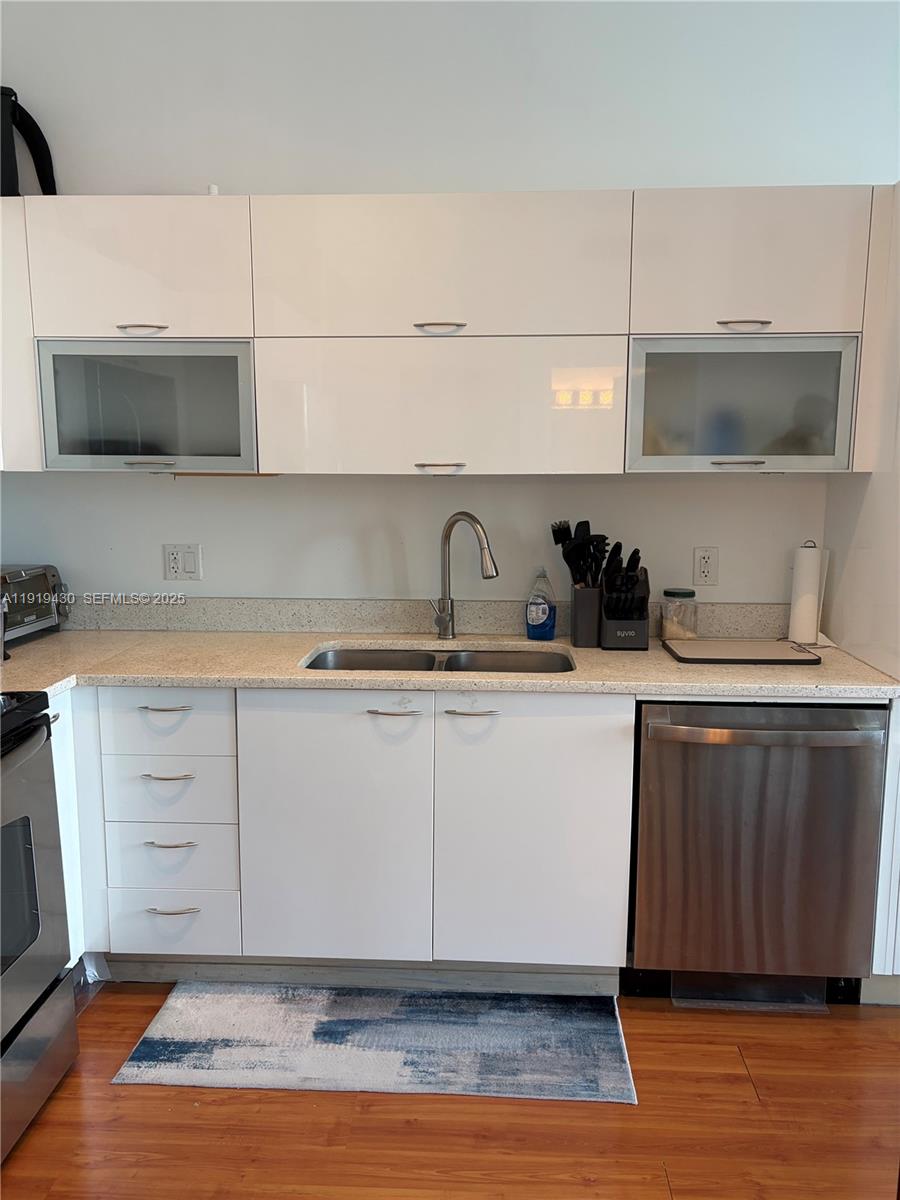 133 Northeast 2nd Avenue, Unit 1017 Miami, FL 33132 - Photo 2 of 14 a kitchen with a sink and cabinets