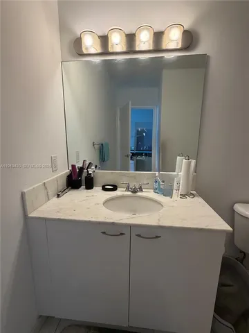 a room with a sink and a mirror
