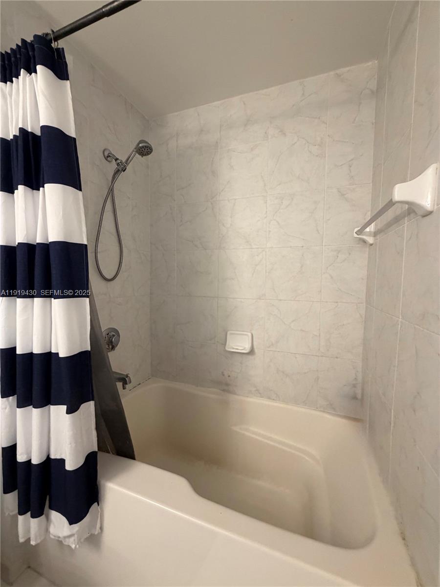 133 Northeast 2nd Avenue, Unit 1017 Miami, FL 33132 - Photo 6 of 14 a bathroom with a bathtub and a shower