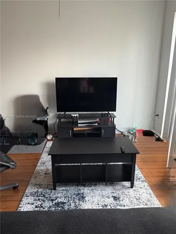a living room with a couch and a flat screen tv