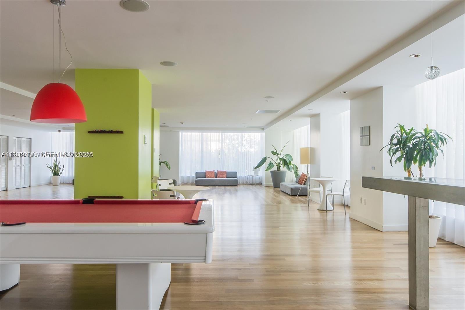133 Northeast 2nd Avenue, Unit 1017 Miami, FL 33132 - Photo 9 of 14 a living room with furniture and wooden floor
