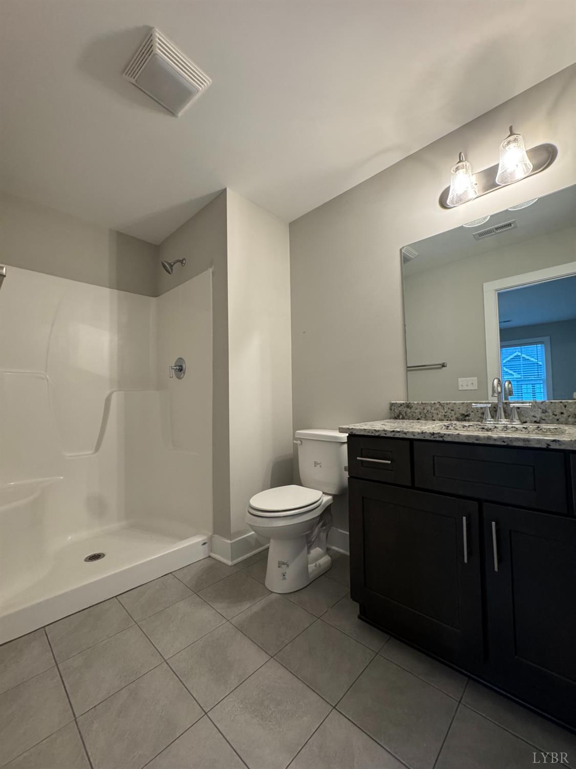 76 High Street Lynchburg, VA 24501 - Photo 16 of 22 a bathroom with a toilet a sink and a mirror