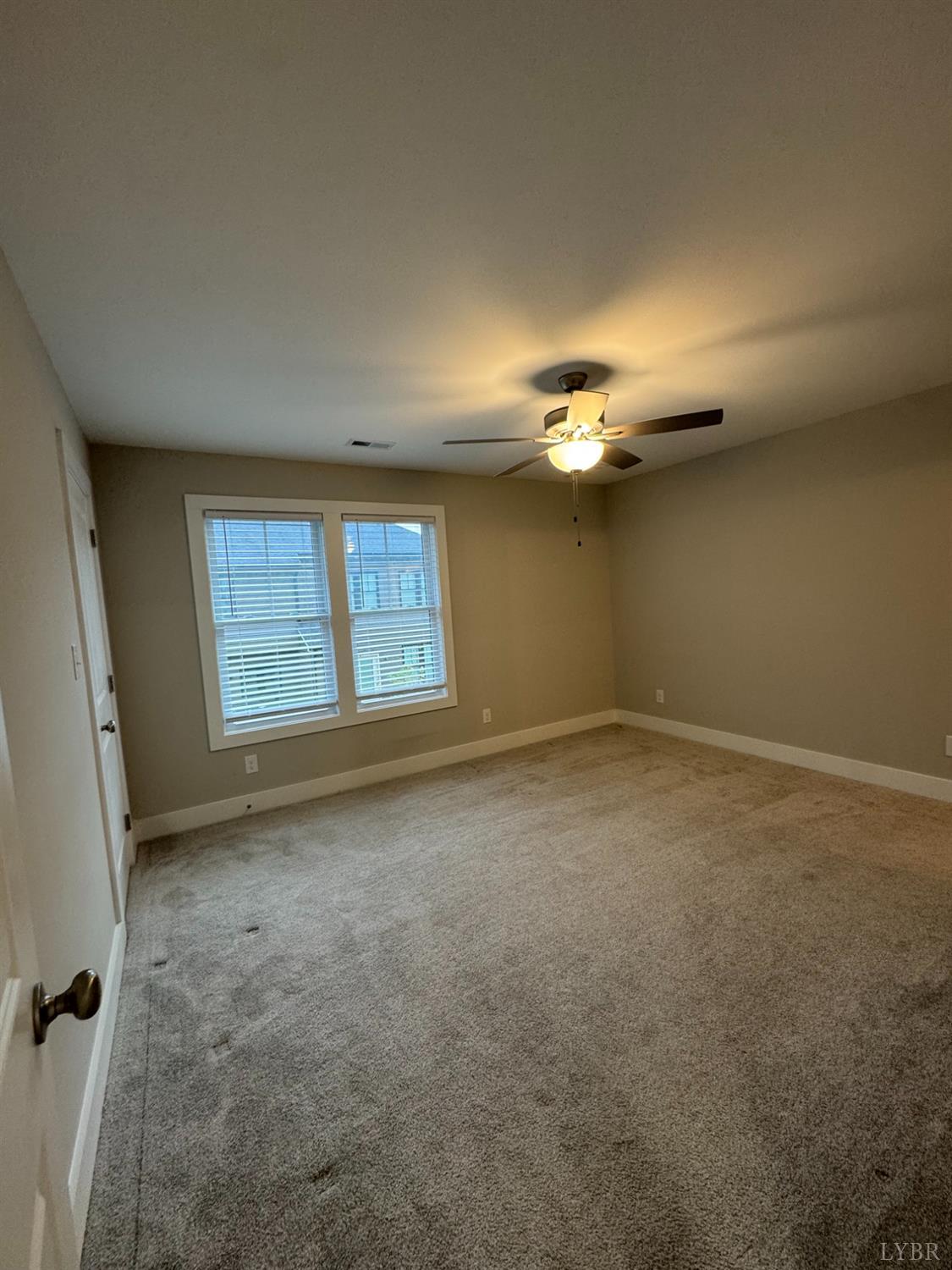 76 High Street Lynchburg, VA 24501 - Photo 17 of 22 an empty room with a chandelier fan and windows