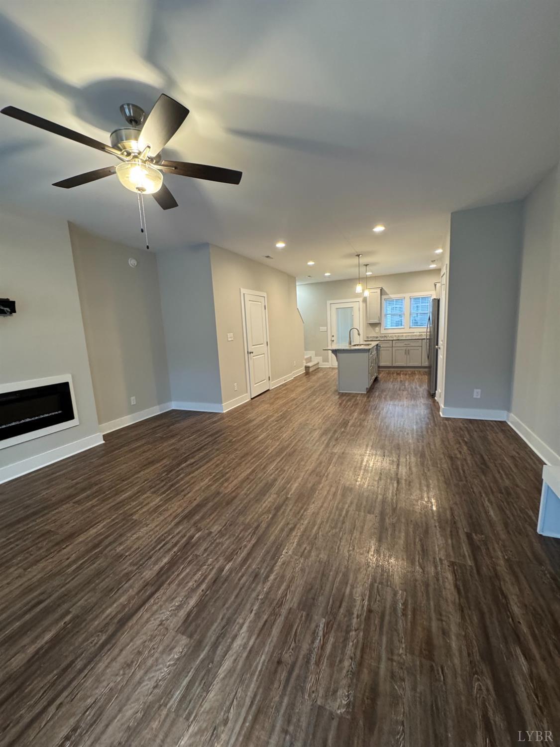 76 High Street Lynchburg, VA 24501 - Photo 3 of 22 a view of an empty room with wooden floor and a ceiling fan