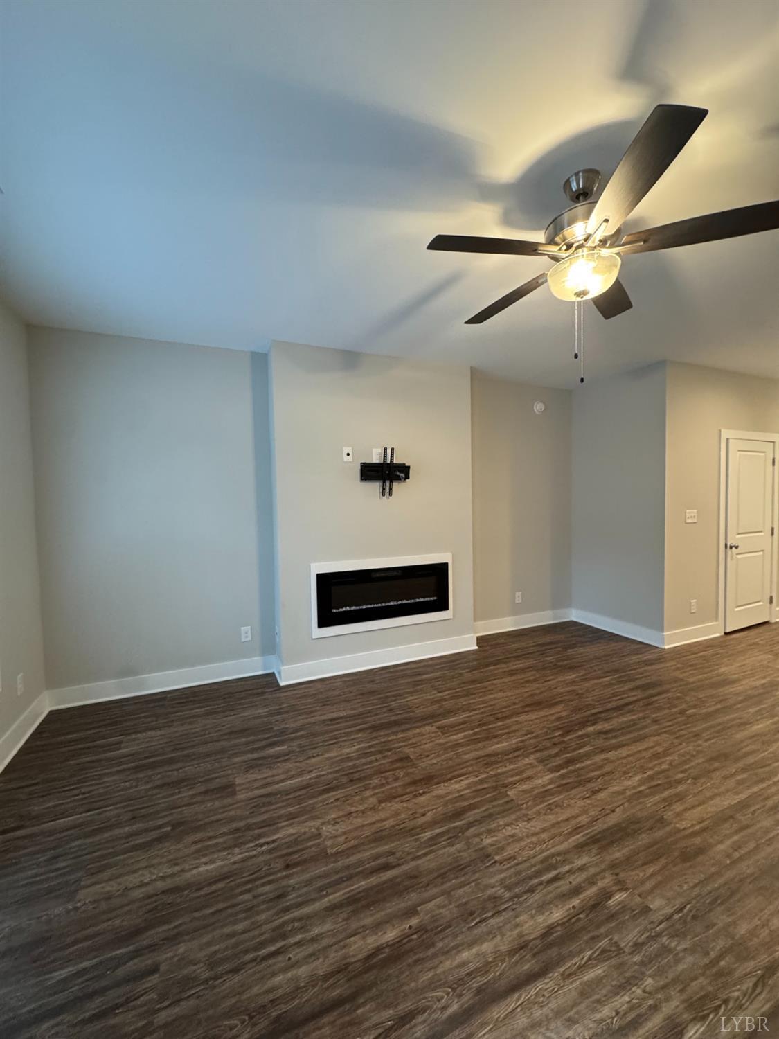 76 High Street Lynchburg, VA 24501 - Photo 4 of 22 a view of an empty room with wooden floor and a ceiling fan