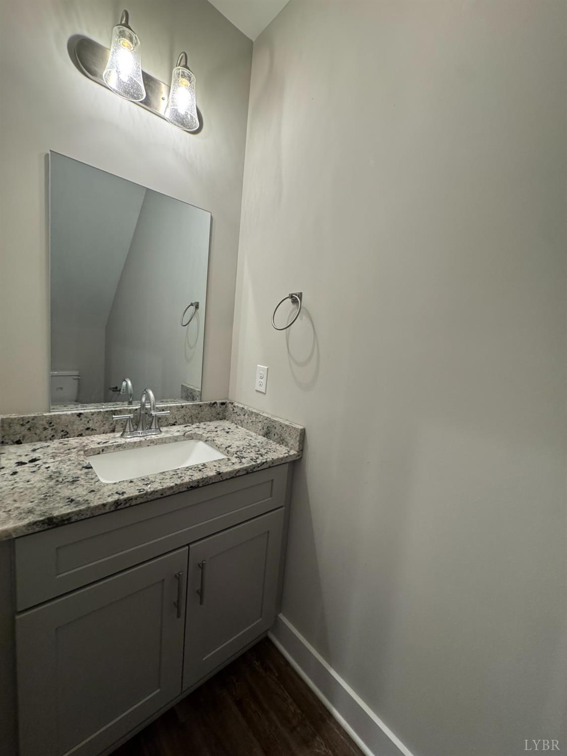 76 High Street Lynchburg, VA 24501 - Photo 10 of 22 a bathroom with a granite countertop sink and a mirror