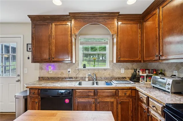 a kitchen with stainless steel appliances granite countertop a sink and cabinets