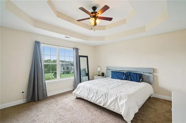 a bedroom with a large bed and a large window