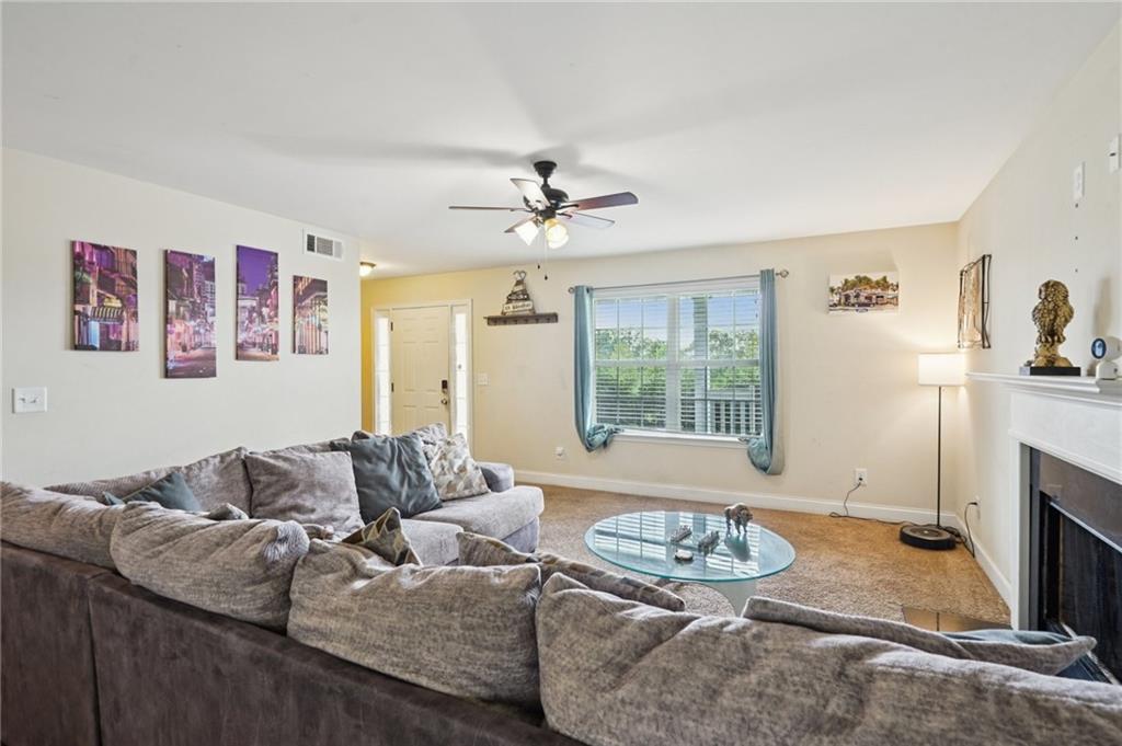 5722 Crystal Way Clermont, GA 30527 - Photo 8 of 35 a living room with furniture and a fireplace