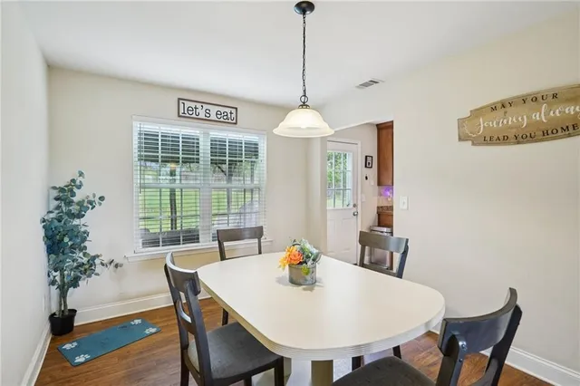 a view of a dining room with furniture window and wooden floor