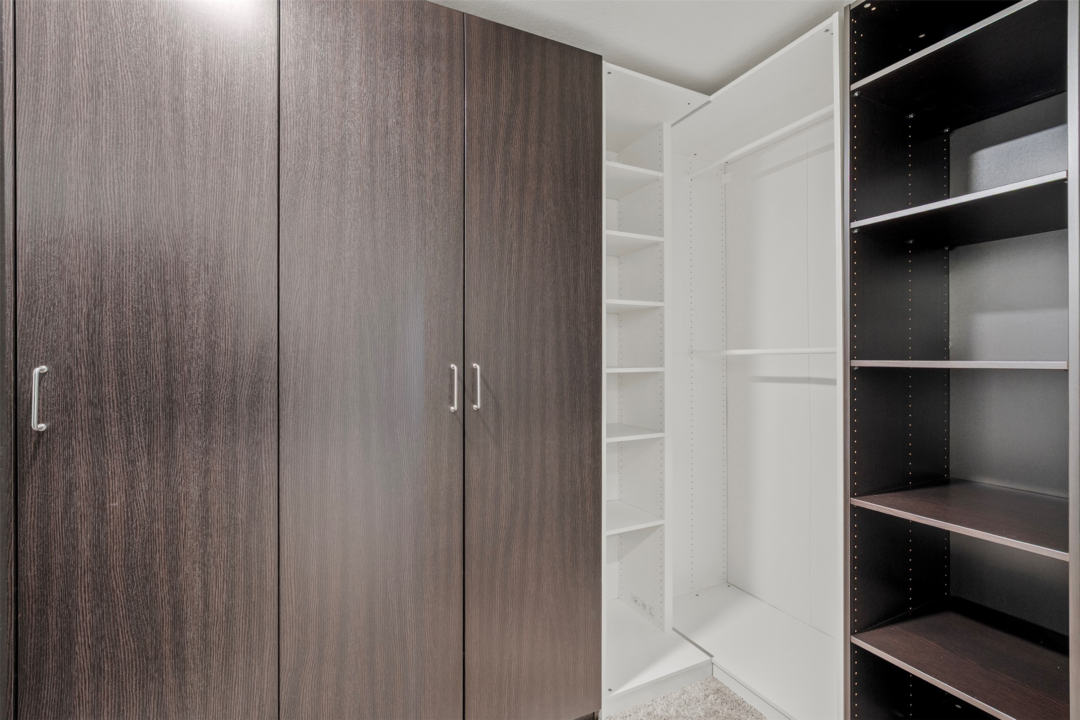 120 Ellinger Road Georgetown, TX 78626 - Photo 9 of 28 Custom closet system featuring dark wood-finish cabinetry, light wood-finish shelving, and a range of storage options