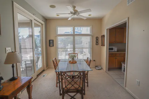a dining room with furniture a chandelier and wooden floor