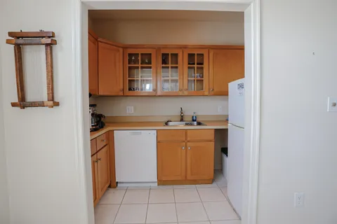 a kitchen with a refrigerator and a sink