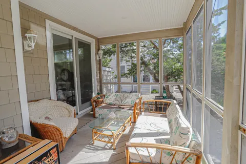 a view of a balcony with couch and table
