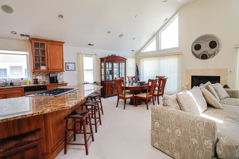 a living room with furniture kitchen view and a fireplace