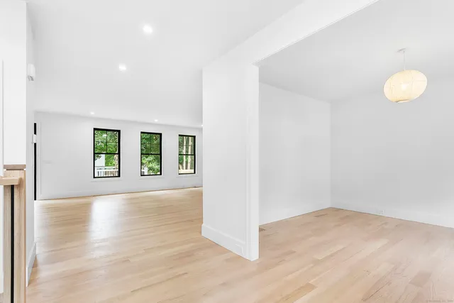 a view of a room with wooden floor and window