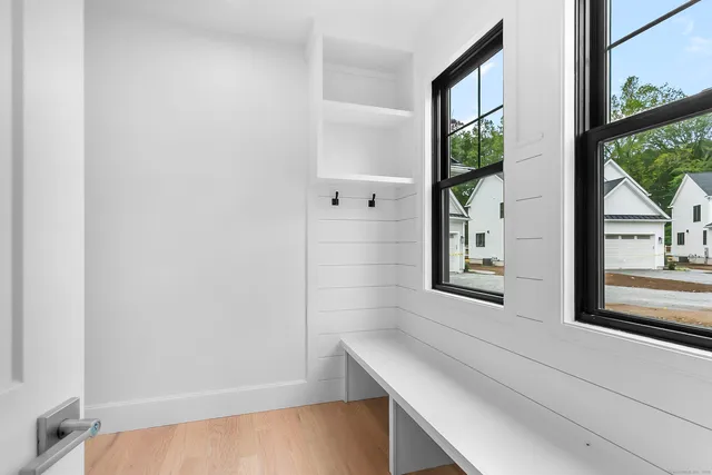 a view of an entryway with wooden floor and door