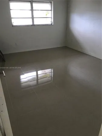 a kitchen with a refrigerator sink and cabinets