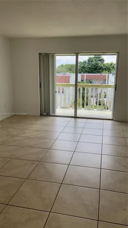 a view of an empty room with a floor to ceiling window