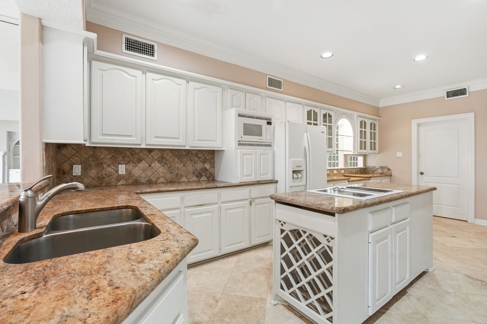 106 Cove Point Montgomery, TX 77356 - Photo 11 of 48 a kitchen with granite countertop a sink and cabinets