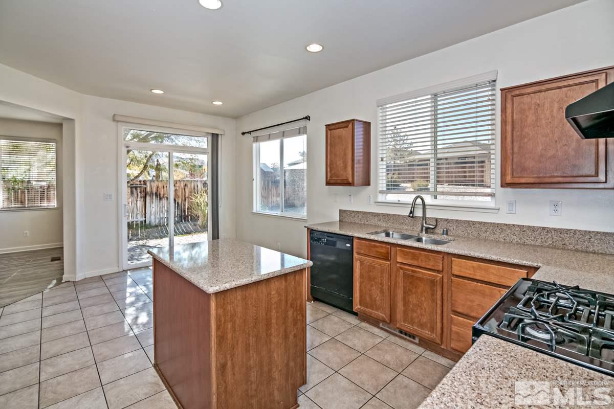 2324 Clementine Lane Reno, NV 89521 - Photo 8 of 23 a kitchen with granite countertop a sink stove and cabinets