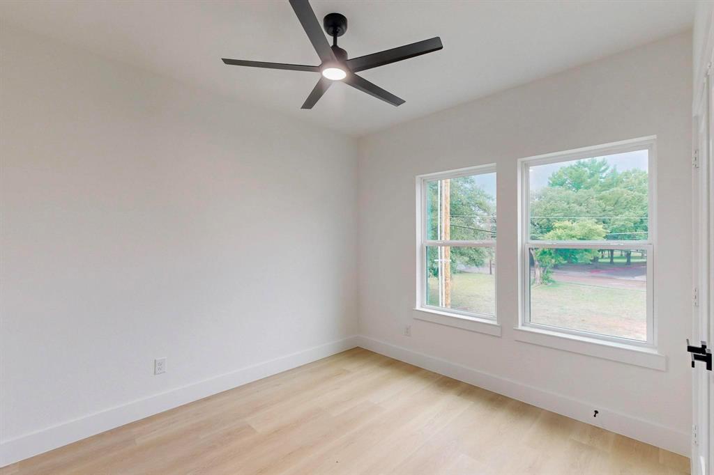 4515 Wahoo Street Dallas, TX 75210 - Photo 23 of 36 Spare room featuring light wood finished floors and ceiling fan