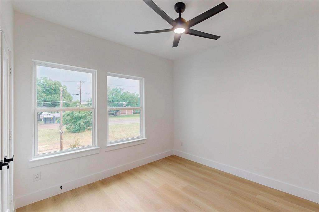 4515 Wahoo Street Dallas, TX 75210 - Photo 27 of 36 Spare room featuring light wood-style flooring and ceiling fan