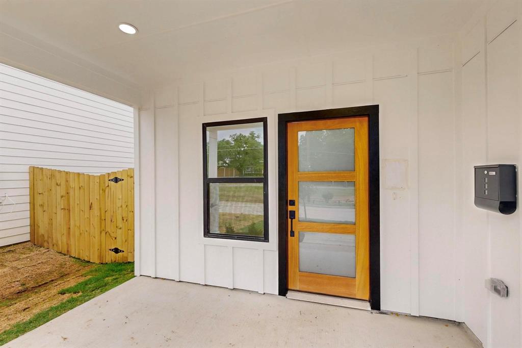 4515 Wahoo Street Dallas, TX 75210 - Photo 4 of 36 Doorway to property with board and batten siding
