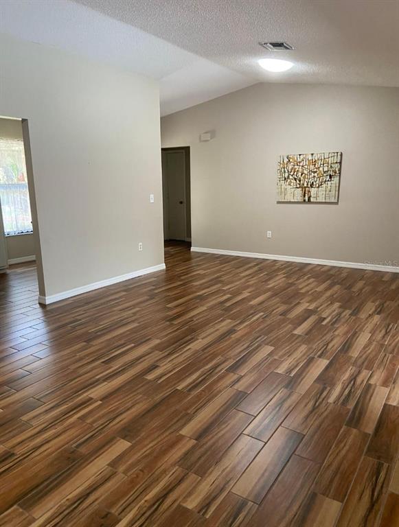 3683 Southeast Brown Road Arcadia, FL 34266 - Photo 3 of 35 a view of an empty room with wooden floor and a window