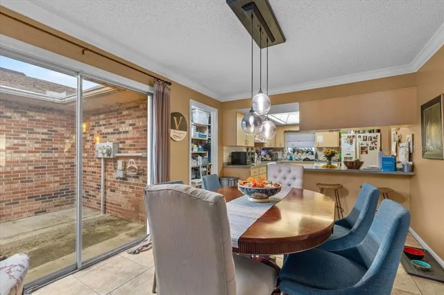 a dining room with furniture and a floor to ceiling window