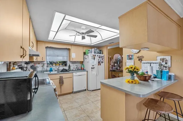 a kitchen with stainless steel appliances granite countertop a sink and cabinets