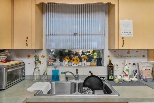 a kitchen with a sink a stove and cabinets