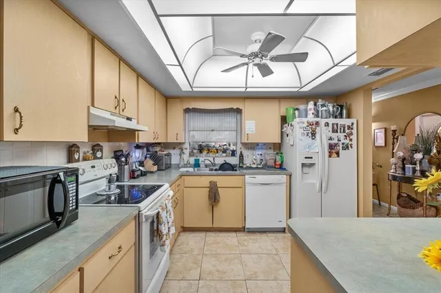 a kitchen with cabinets and wooden floor