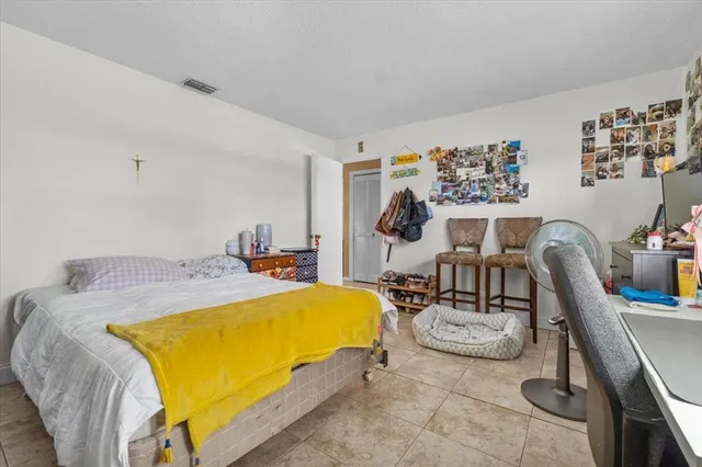 a bed room with two beds and with chair