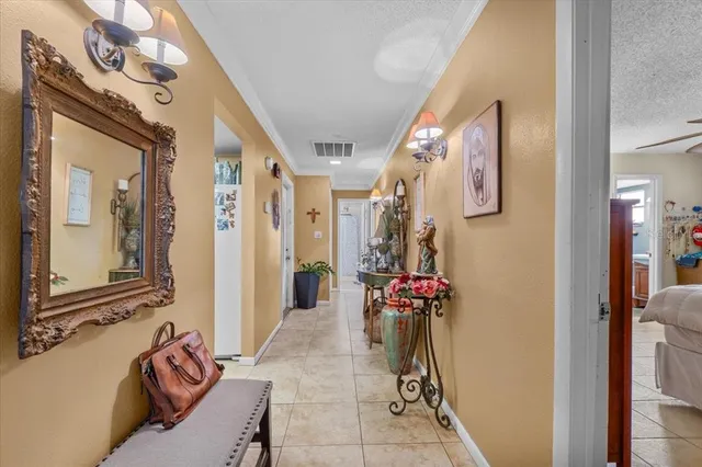 a view of a hallway with furniture and a chandelier