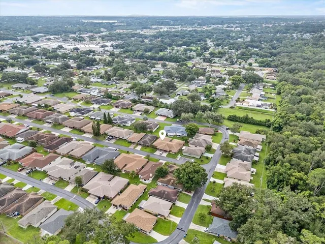 an aerial view of residential houses with outdoor space
